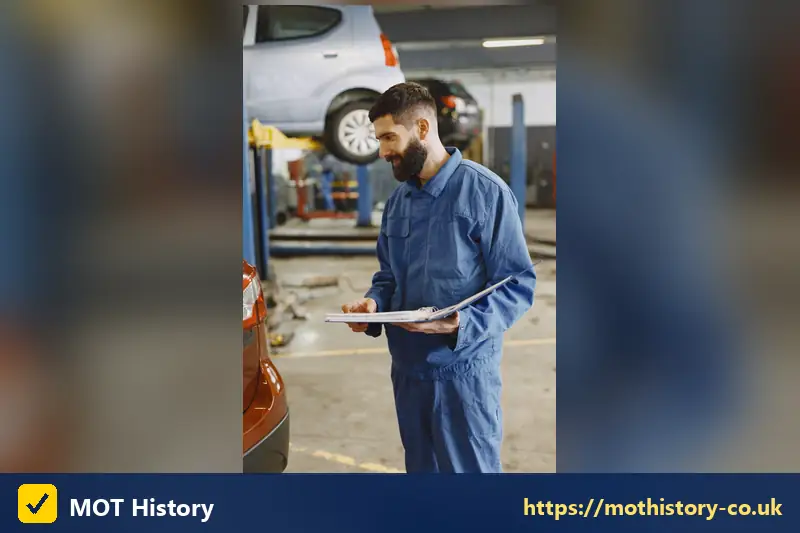 Mechanic holding a clipboard in a garage bay - free finance check