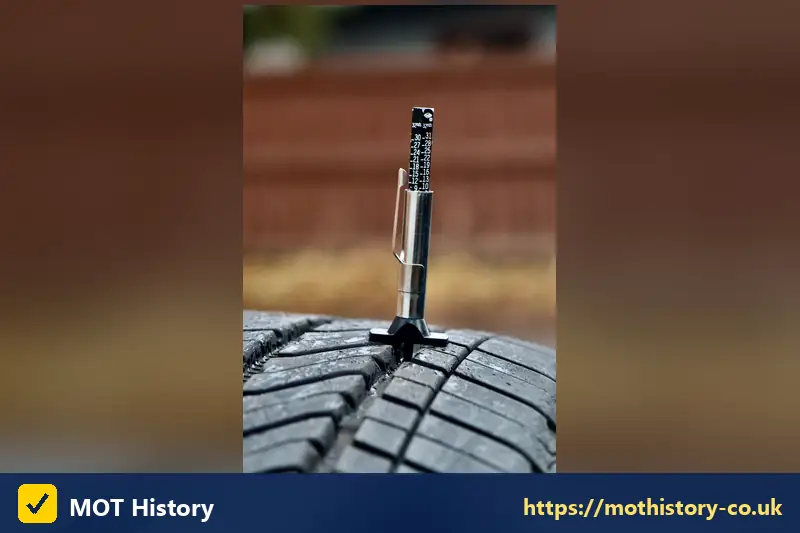 Tyre tread depth gauge standing in a tyre groove - how long mot certificate valid for