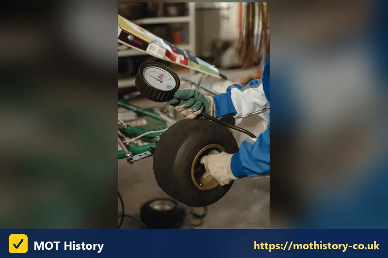 Tyre pressure gauge being used on a wheel - ireland mot check