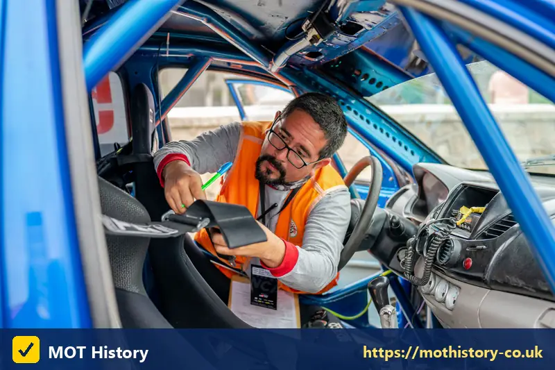 Inspector using a tablet to check the inside of a car - private car insurance