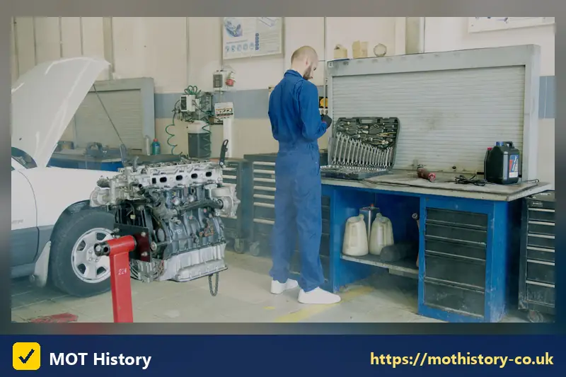 Mechanic beside an engine on a workshop bench - sorn car insurance