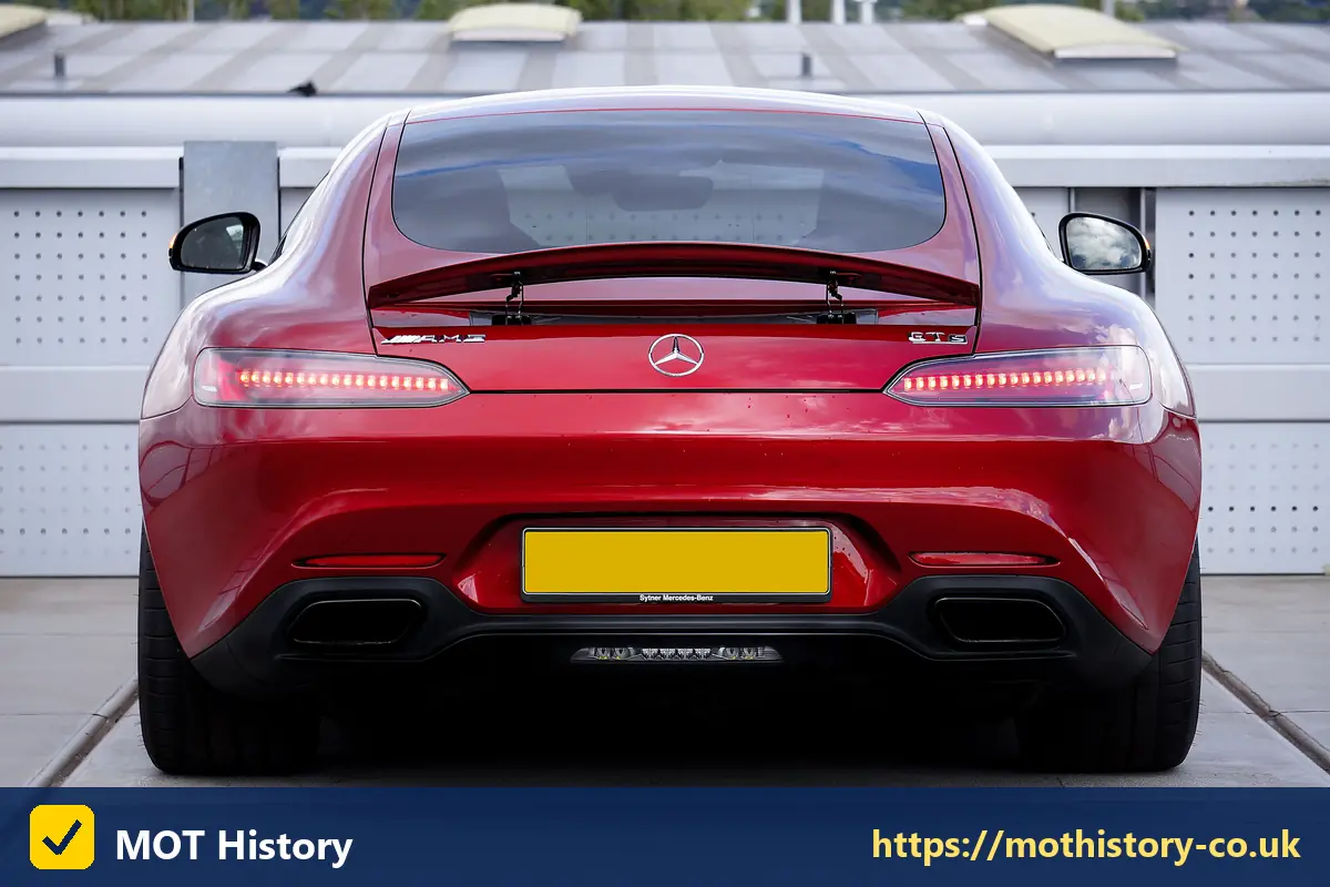 Rear of a red sports car with a yellow number plate - car vehicle identification number