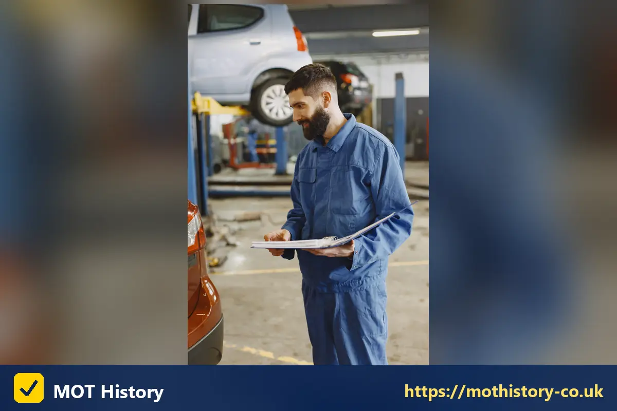Mechanic holding a clipboard in a garage bay - how much is insurance for a new driver
