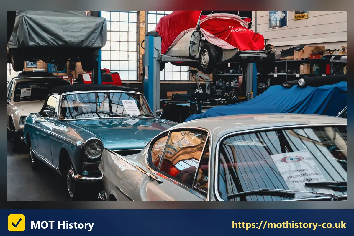 Classic cars parked in a restoration workshop - sorn insurance