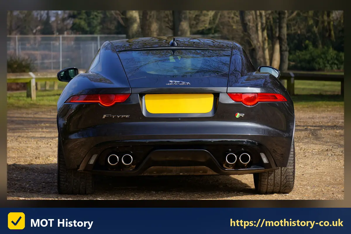Rear of a dark coupe with a yellow number plate - what is vin number for vehicle