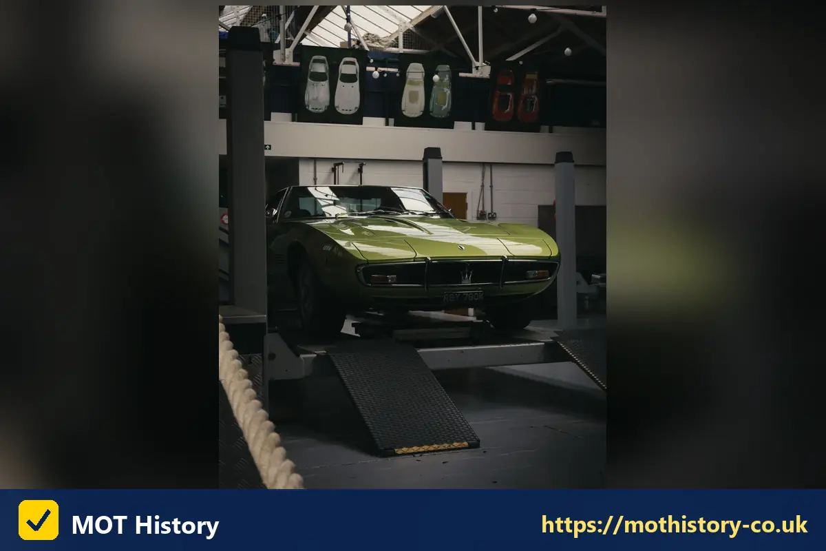 Classic green sports car raised on a garage ramp - why is my mot not showing online